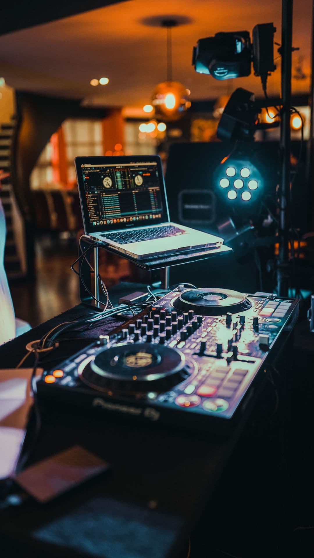 DJ booth and console lit in the venue