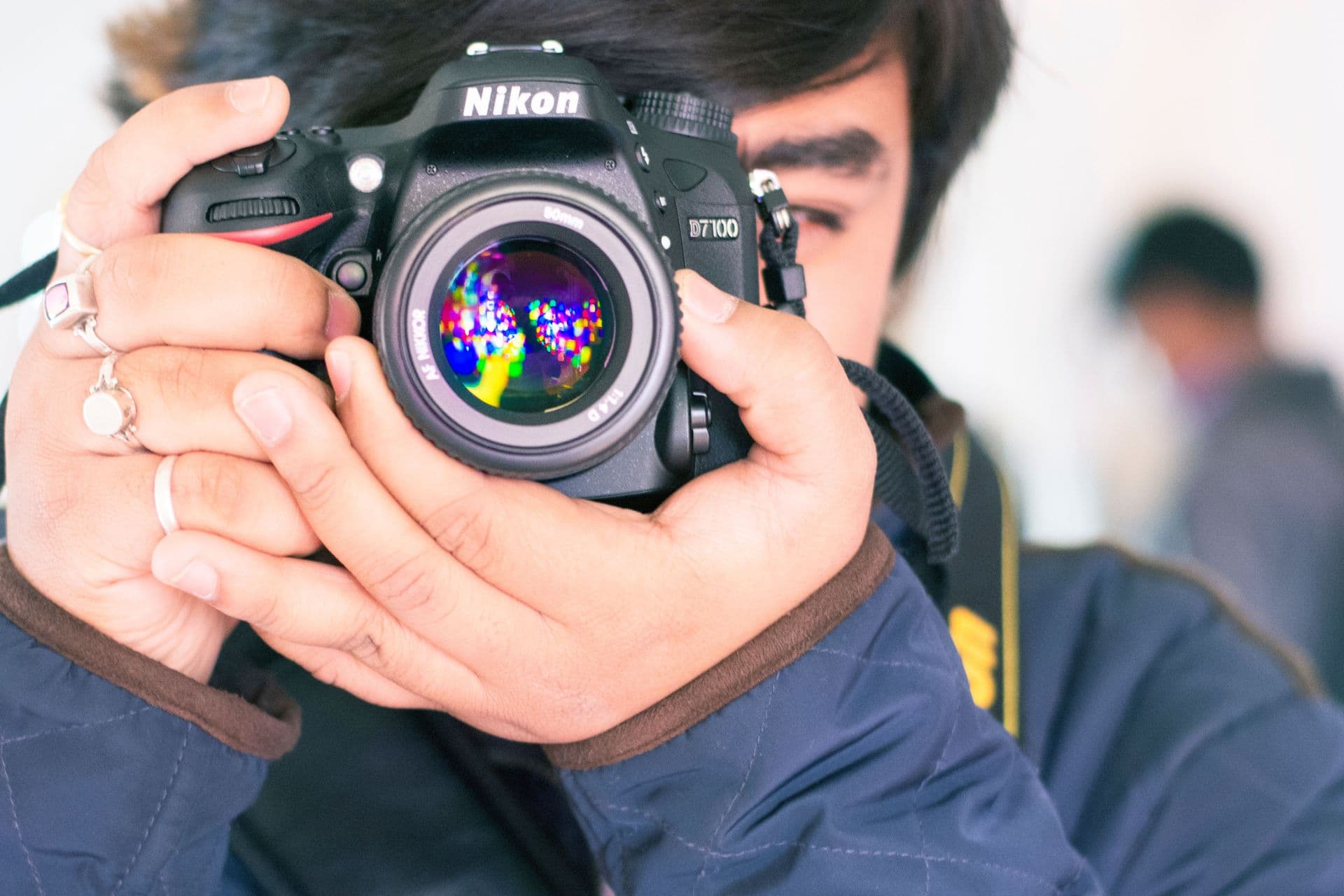 Photographer raising a professional camera at an event