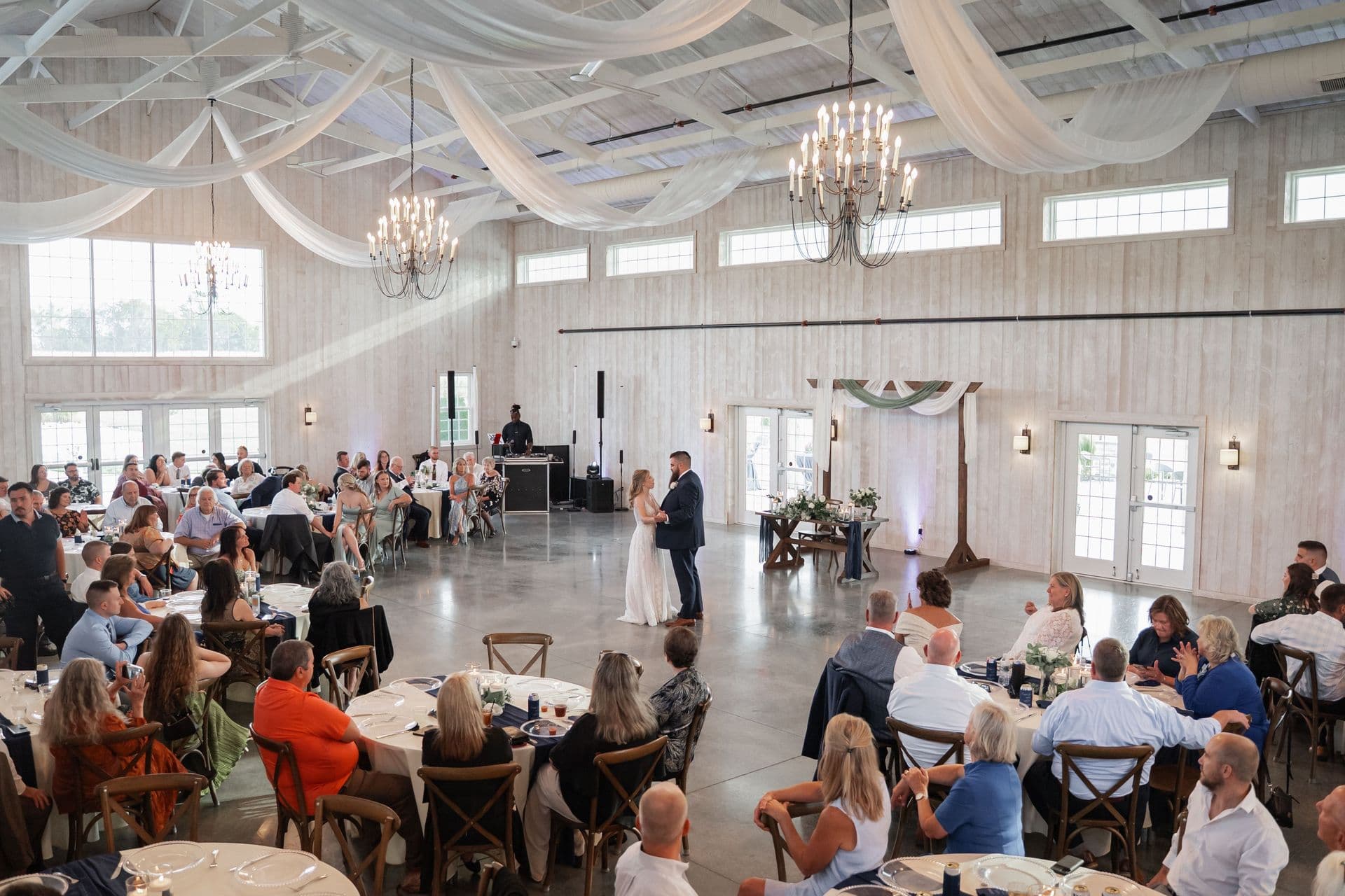 Reception hall with ceiling drapery and seated guests