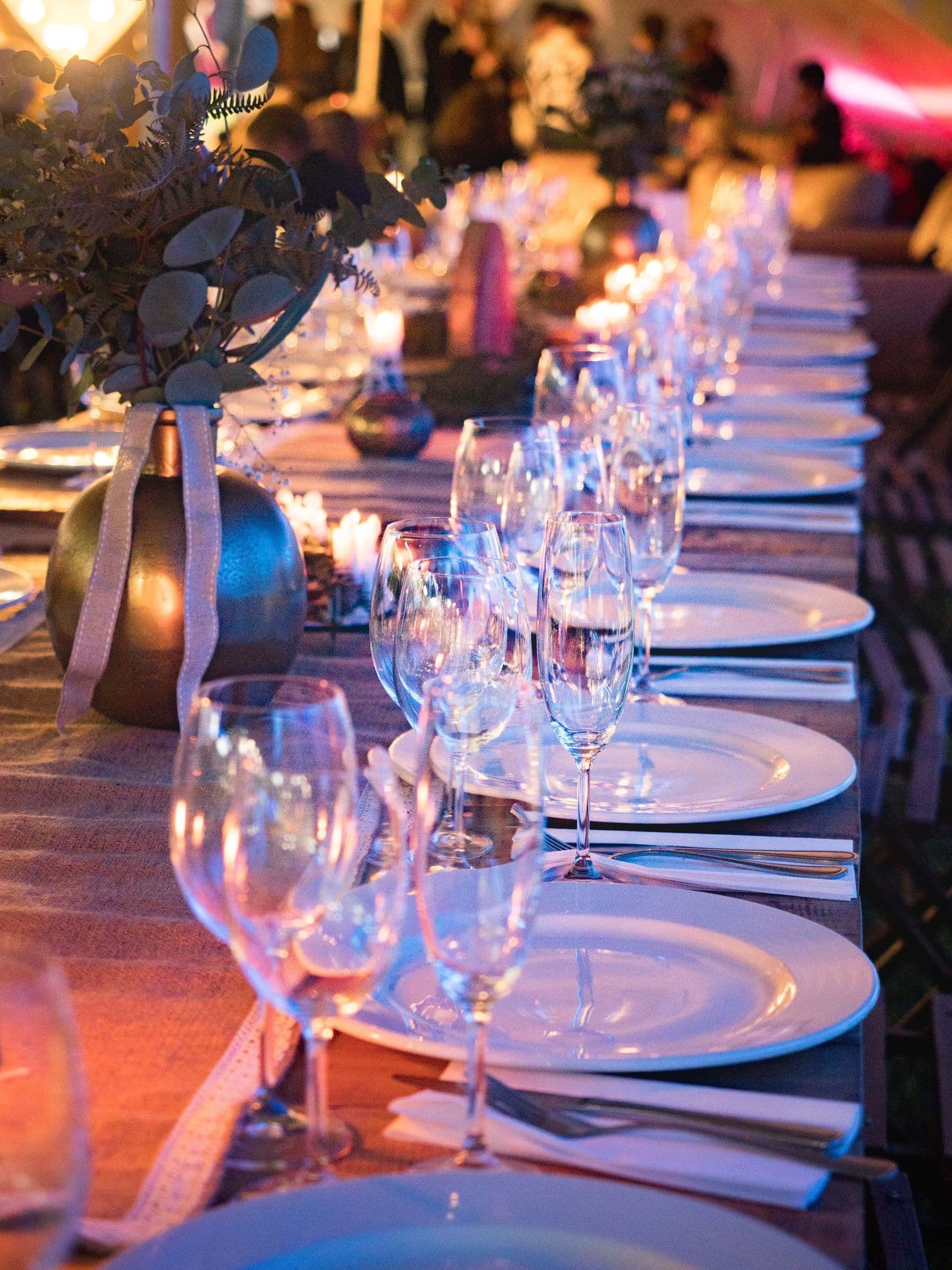 Candlelit tablescape with glassware and place settings
